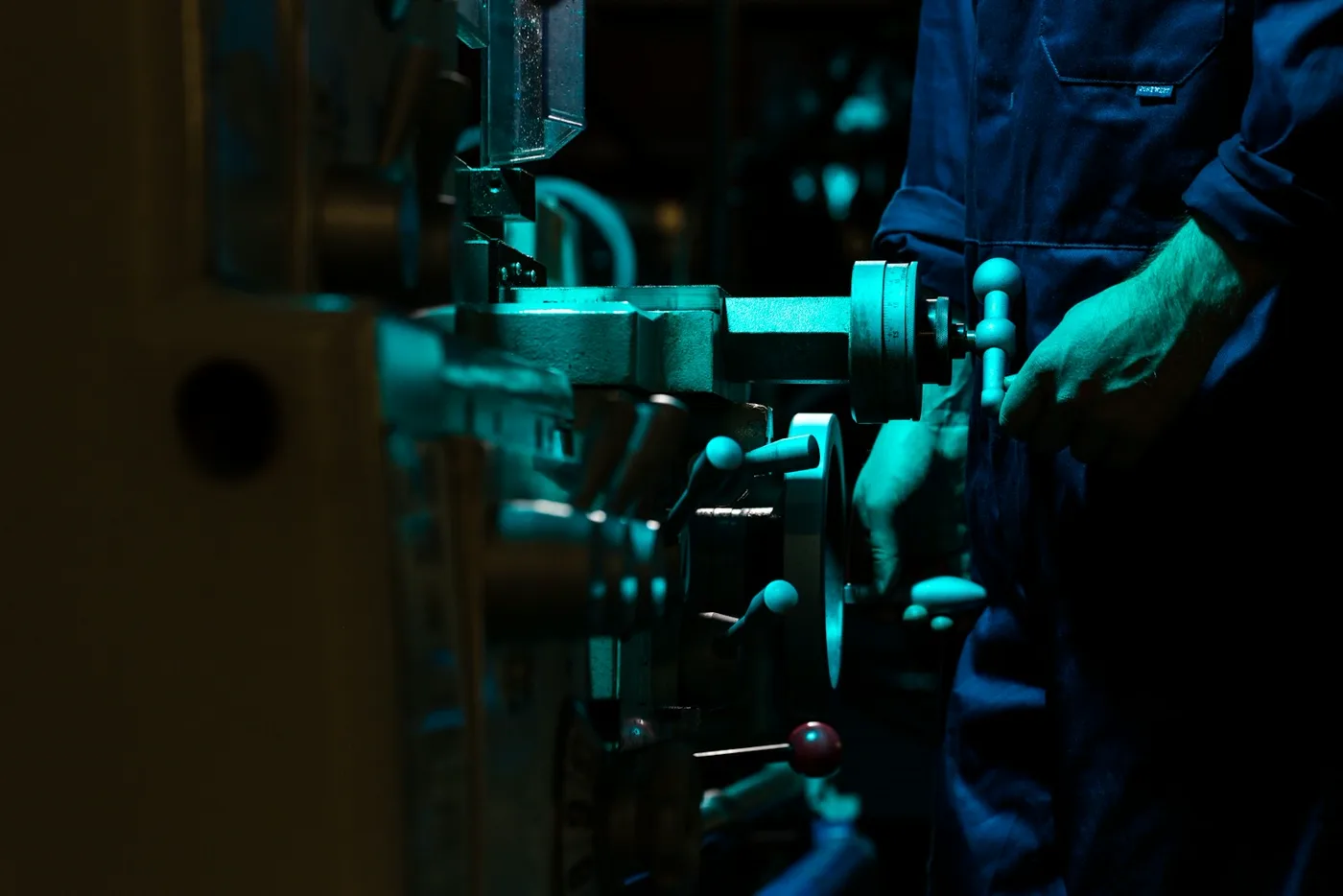 Technician operating industrial machining equipment during a diagnostic check